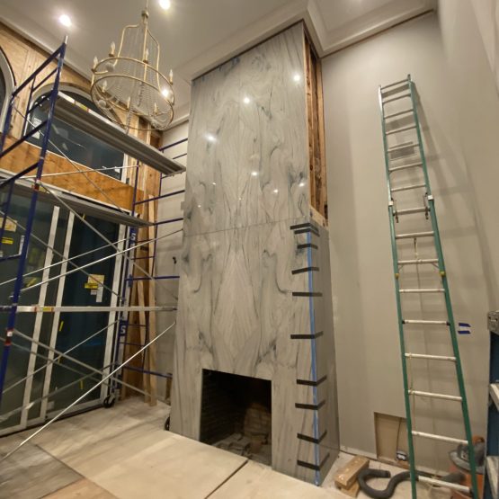 Quartzite floor to ceiling miter fireplace installation